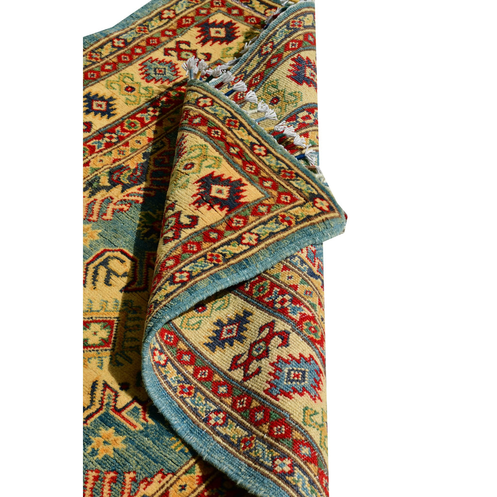 Handmade Afghan Aqcha Wool Rug 4x5 ft partially rolled showing plush wool thickness and edge